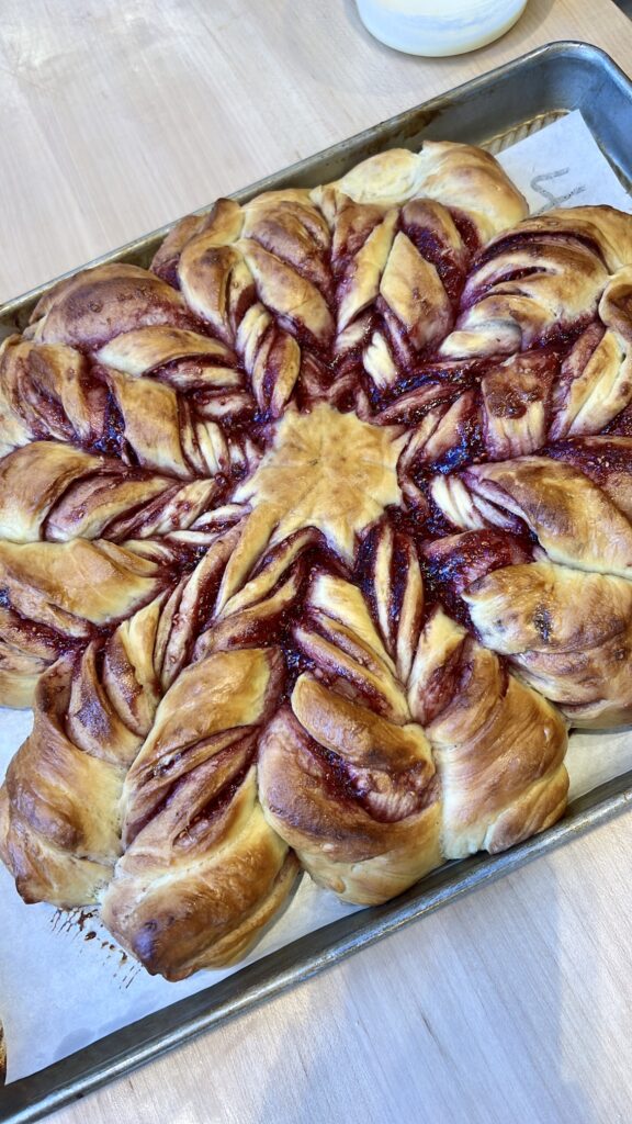 Freshly baked raspberry snowflake wreath bread on a pan at the Sur La Table Festive Bread Workshop. 