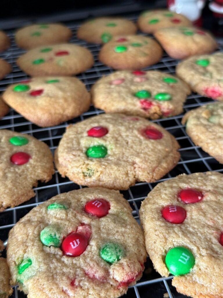freshly baked christmas m&m cookies resting on cooling rack