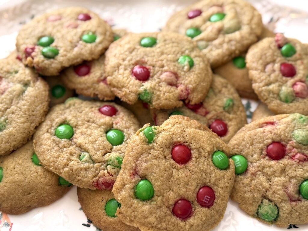 a festive plate of a dozen or so christmas m&m cookies