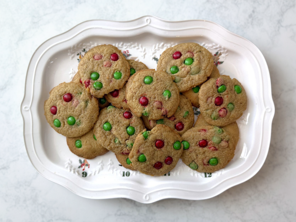christmas m&m cookies on festive decorative holiday plate sitting on countertop