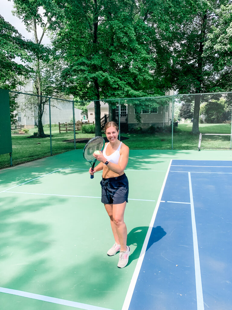 girl in 30's playing tennis