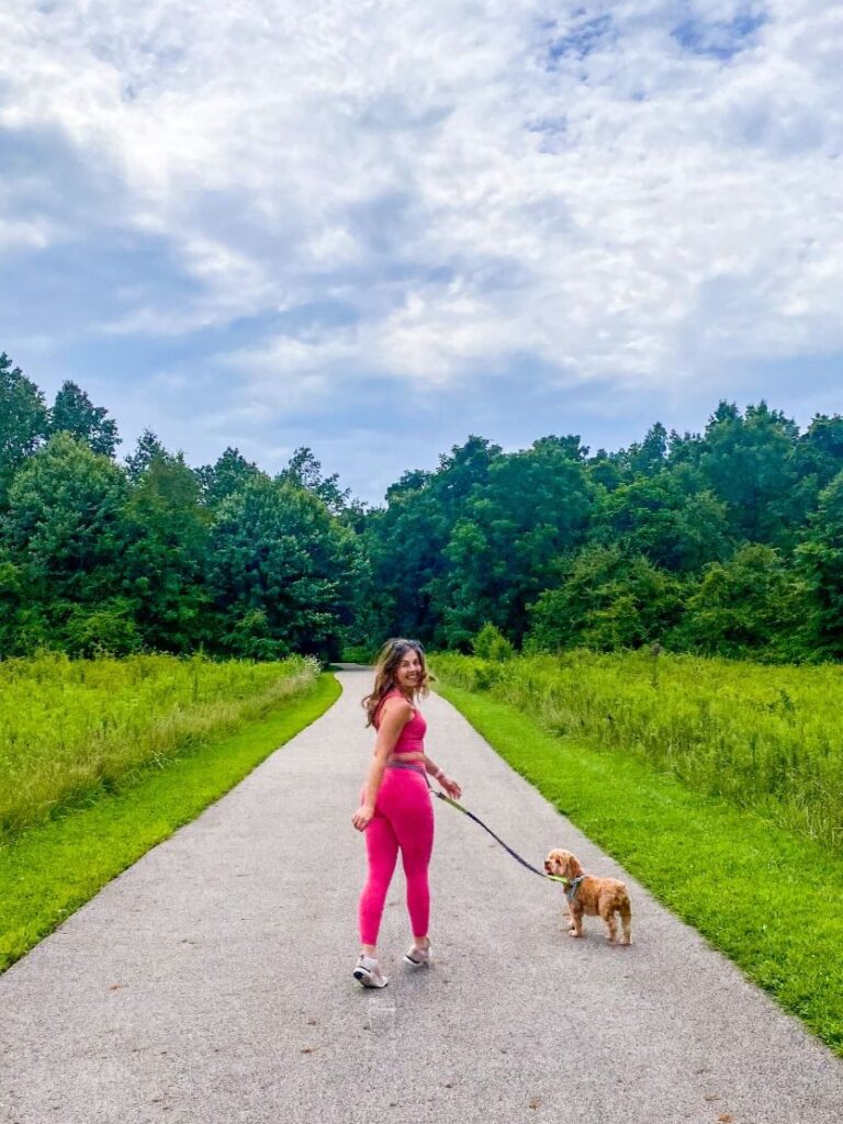 Steph Maupin, Founder of Reach Wellth walking her dog - answers the question, "is walking enough exercise when you're too tired?" Spoiler alert: Absolutely.