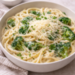 a bowl of pasta with broccoli and creamy high protein cottage cheese alfredo sauce