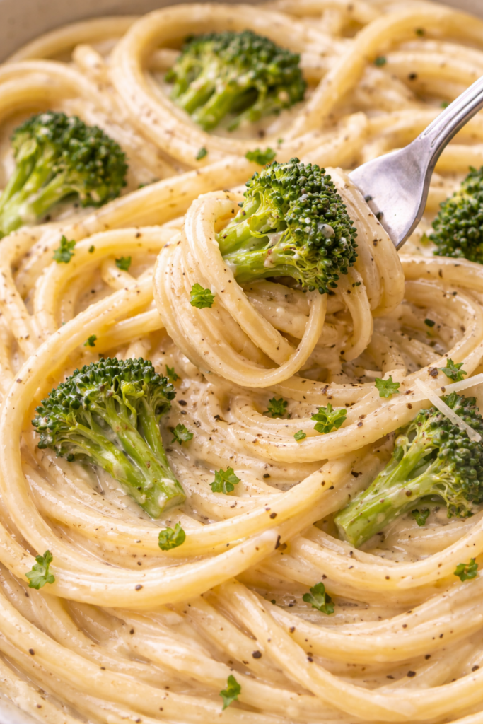 close up image of creamy cottage cheese alfredo sauce with broccoli pasta