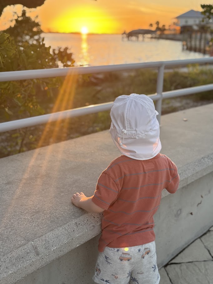 Toddler watching the sunset on a family vacation in Englewood, Florida