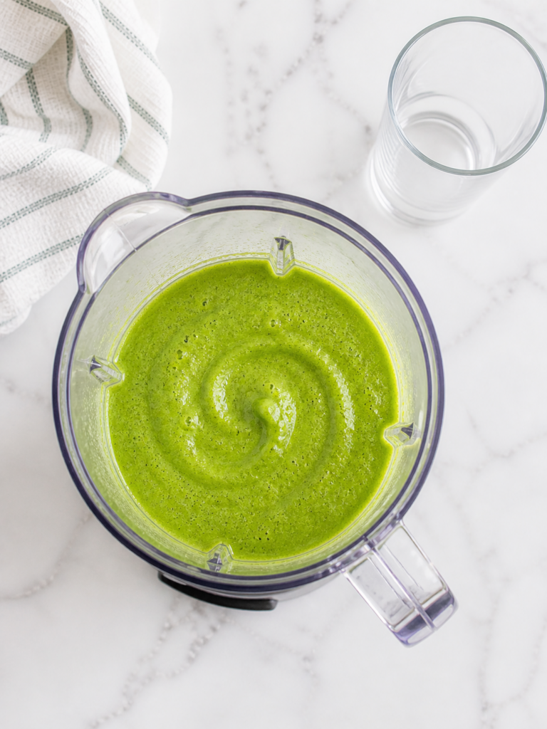panera green passion smoothie blended in blender on marble countertop