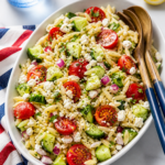 large oval bowl of summer orzo pasta salad