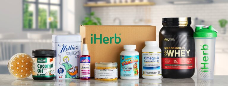 Sampling of products from iHerb lined up on countertop in front of an iHerb shipping box in a bright, modern kitchen.