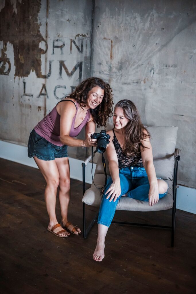 Boudoir photographer showing a client her images on the camera back