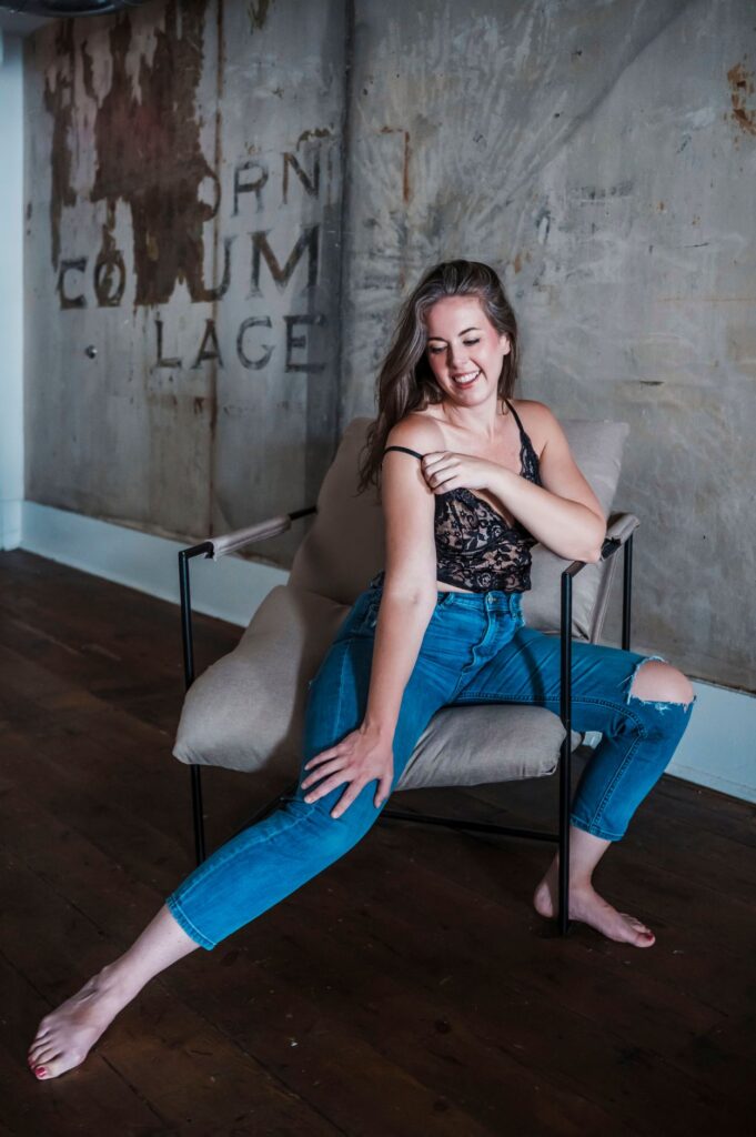 Woman laughing in lace and jeans during a Columbus Ohio boudoir session