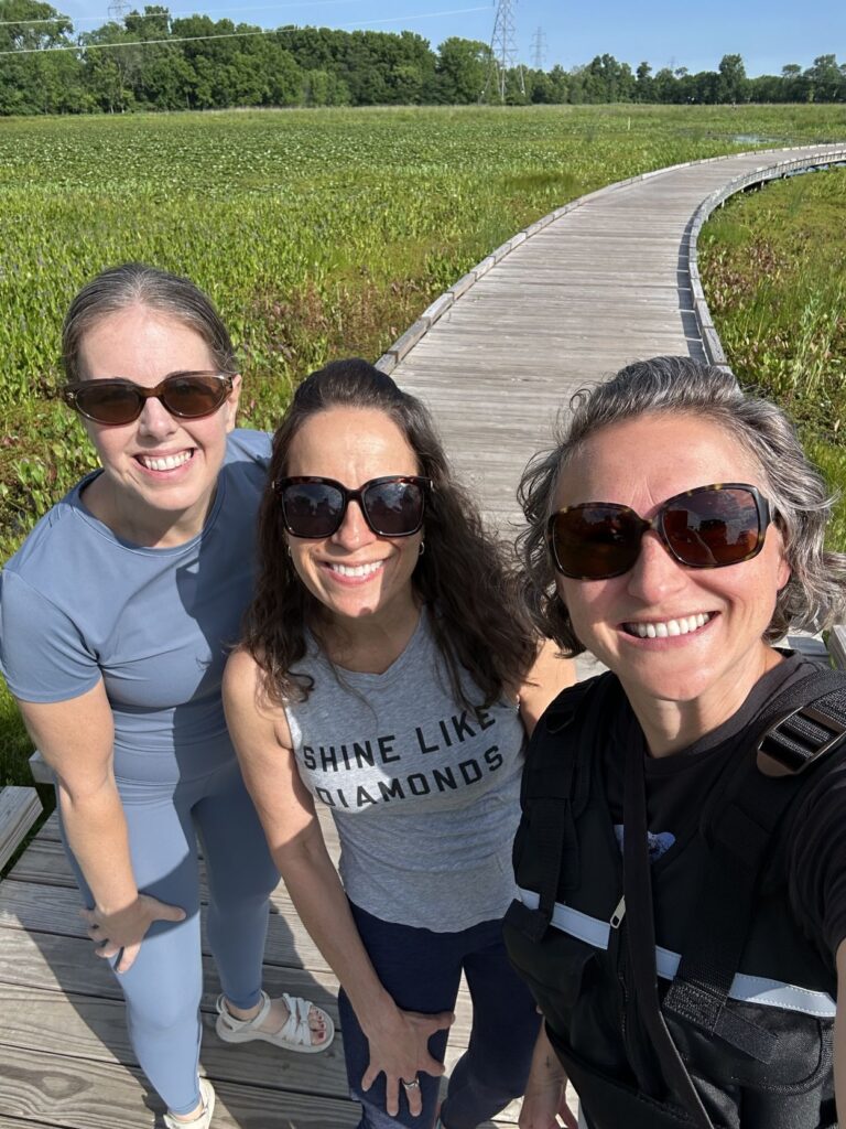 three women walking together to discuss business while prioritizing their health